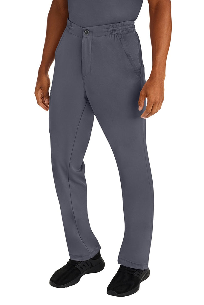 A male clinical nurse specialist wearing an HH-Works Men's Ryan Multi-Pocket Cargo Scrub Pant in Pewter featuring a hidden drawstring & elastic waistband.
