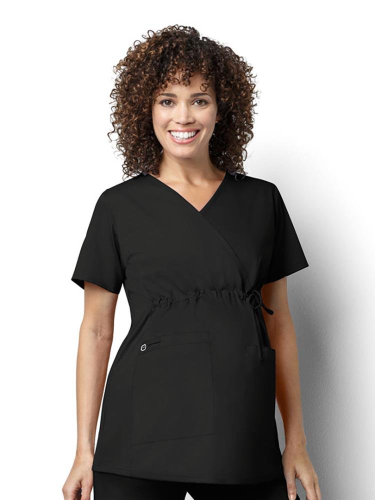 A female Occupational Therapist wearing a WonderWork by Wonderwink Women's Maternity Mock Wrap Scrub Top in black size 2X.
