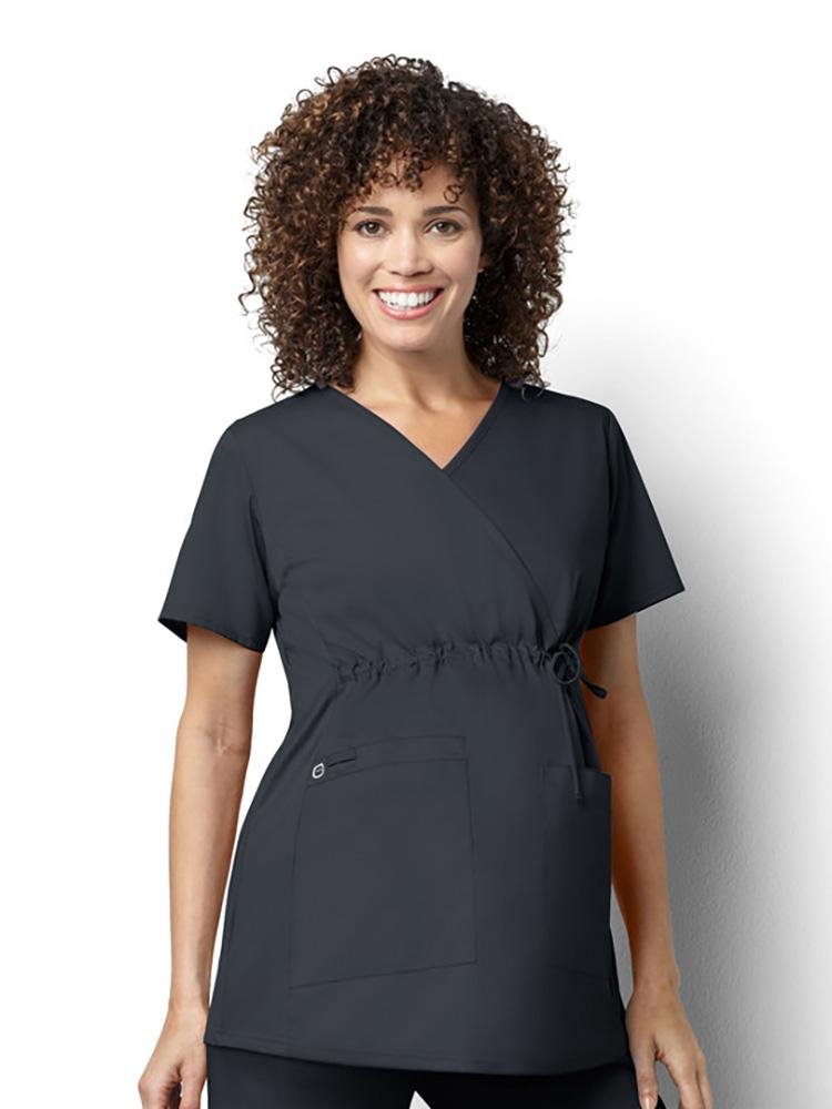 A female Obstetrician wearing a WonderWork Women's Maternity Mock Wrap Scrub Top in pewter size small featuring a longer length for added coverage.