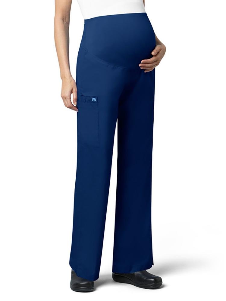 A pregnant LPN wearing a WonderWork Women's Maternity Cargo Scrub Pant in navy size large featuring a total of 3 pockets.