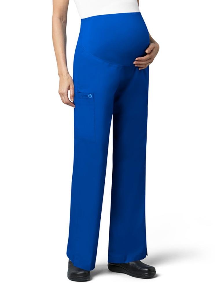 A female Nutritionist wearing WonderWink Women's Maternity Cargo Scrub Pant in royal size small featuring WonderWORK active twill fabric.
